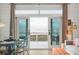 Open living space featuring a dining table, comfortable seating, and doors that lead to a scenic outdoor view at 220 W Arctic Ave, Folly Beach, SC 29439
