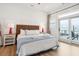 Bright bedroom with balcony access, ocean views, and stylish furnishings at 220 W Arctic Ave, Folly Beach, SC 29439