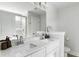 Bright bathroom features double sinks with white cabinets, a large mirror, and a glass enclosed shower at 2312 Oakland Rd, Charleston, SC 29414