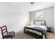 Cozy bedroom with a black metal bed frame, area rug, and a sunny window at 2312 Oakland Rd, Charleston, SC 29414