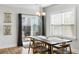 Charming dining area featuring a wooden table, sliding glass doors to the backyard, and modern lighting at 2312 Oakland Rd, Charleston, SC 29414