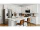 Modern kitchen features white cabinets, stainless steel appliances, and a spacious island with seating at 2312 Oakland Rd, Charleston, SC 29414