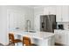 Bright kitchen with white cabinetry, stainless steel appliances, and a center island with bar stool seating at 2312 Oakland Rd, Charleston, SC 29414