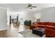 Open-concept living room with an orange sectional, hardwood floors, and a dining area at 2312 Oakland Rd, Charleston, SC 29414