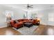 Comfortable living room with an orange sectional, ottoman, and hardwood flooring at 2312 Oakland Rd, Charleston, SC 29414
