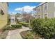 Serene yard is adorned with manicured shrubs, and leading to a residence filled with timeless appeal at 244 Ashley Ave, Charleston, SC 29403