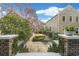Backyard garden featuring a serene stone patio surrounded by lush greenery and blooming trees at 244 Ashley Ave, Charleston, SC 29403