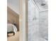 Bright marble shower stall with a skylight and a view of the bedroom at 244 Ashley Ave, Charleston, SC 29403