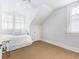 Cozy bedroom with a ceiling fan, dormer windows, and neutral walls at 244 Ashley Ave, Charleston, SC 29403