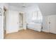 Bright bedroom with ceiling fan, bed, and doorways to bathroom and hallway at 244 Ashley Ave, Charleston, SC 29403