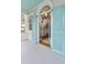 Inviting entryway with blue shutters, arched doorway, and view of staircase at 244 Ashley Ave, Charleston, SC 29403