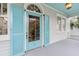Exterior front door with blue shutters and white siding, offering a charming welcome at 244 Ashley Ave, Charleston, SC 29403