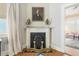 Fireplace details with a view into another beautifully furnished room, offering warmth and charm at 244 Ashley Ave, Charleston, SC 29403