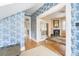 Elegant foyer with blue floral wallpaper, hardwood floors, and view of the living room at 244 Ashley Ave, Charleston, SC 29403