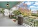 Inviting front porch with brick columns and decorative railings create a relaxing entryway at 244 Ashley Ave, Charleston, SC 29403