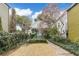 Inviting two-story home with landscaped yard, blooming tree, and chairs to enjoy the curb appeal at 244 Ashley Ave, Charleston, SC 29403