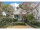 Charming two-story home with a landscaped front yard, blooming tree and inviting light blue entry door at 244 Ashley Ave, Charleston, SC 29403