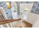 Hallway with blue patterned wallpaper. Door leading to outside balcony at 244 Ashley Ave, Charleston, SC 29403