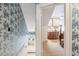 Hallway featuring blue patterned wallpaper leading to a bedroom at 244 Ashley Ave, Charleston, SC 29403