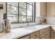 Sunlit kitchen features bright marble countertops and large sink with exterior view at 244 Ashley Ave, Charleston, SC 29403