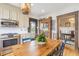 Bright kitchen with stainless appliances, wood table, and view of breakfast room at 244 Ashley Ave, Charleston, SC 29403