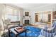 Cozy living room featuring a fireplace, hardwood floors, and an abundance of natural light at 244 Ashley Ave, Charleston, SC 29403