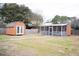 Large backyard with storage shed, screened in porch, and mature trees at 2590 Otranto Rd, North Charleston, SC 29406