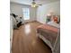 Bright bedroom featuring neutral walls, exercise bike, and a comfortable bed with stylish floral pillows at 2590 Otranto Rd, North Charleston, SC 29406