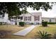 Charming single-story home featuring a welcoming front porch and a well-manicured lawn at 2590 Otranto Rd, North Charleston, SC 29406