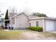 A cozy home exterior boasts a well-kept lawn and an attached garage for convenience at 2590 Otranto Rd, North Charleston, SC 29406