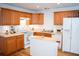 Bright kitchen features wooden cabinets, white appliances, and center island at 2590 Otranto Rd, North Charleston, SC 29406