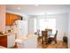 Bright kitchen with white appliances, wood cabinets, and an adjacent dining area with seating at 2590 Otranto Rd, North Charleston, SC 29406