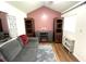 Cozy living room features a gray sofa, electric fireplace and a cool pink accent wall at 2590 Otranto Rd, North Charleston, SC 29406