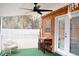 Cozy screened porch featuring comfortable seating, decorative lights, and an outdoor ceiling fan at 2590 Otranto Rd, North Charleston, SC 29406