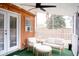 Screened porch with outdoor seating, fan, and string lights at 2590 Otranto Rd, North Charleston, SC 29406