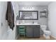 Stylish bathroom with gray cabinets, bright vanity lights, decorative towel hanging near the door at 267 Cameron St, Summerville, SC 29486
