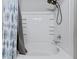 Well-lit bathroom featuring a shower with a neutral shower curtain, storage shelves and chrome hardware at 267 Cameron St, Summerville, SC 29486