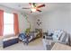 Charming bedroom featuring dinosaur themed decor, a fan, a comfortable armchair and natural light from the window at 267 Cameron St, Summerville, SC 29486