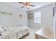 Small bedroom with twin bed, ceiling fan, wooden shelves and cabinet, and a window at 267 Cameron St, Summerville, SC 29486