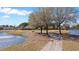 Picturesque community featuring a lake, walking trail, a bench for resting, and lush landscaping for a serene living experience at 267 Cameron St, Summerville, SC 29486