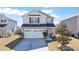 Charming two-story home featuring a two car garage, welcoming front porch, and well-manicured landscaping at 267 Cameron St, Summerville, SC 29486
