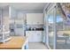 Modern kitchen with white cabinets, stainless steel appliances, and sliding glass doors leading to the patio at 267 Cameron St, Summerville, SC 29486