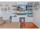 Cozy living room boasts a fireplace with a large screen tv, floating shelves and gleaming hardwood floors at 267 Cameron St, Summerville, SC 29486
