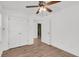 Bedroom with hardwood floors, ceiling fan, walk-in closet with plenty of storage, and an interior door at 2969 Bobo Rd, Mount Pleasant, SC 29466