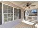 Inviting front porch with a ceiling fan, decorative railing, and a view of the front yard at 2969 Bobo Rd, Mount Pleasant, SC 29466
