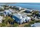 Aerial view of a coastal home featuring a metal roof, palm trees, and nearby ocean access at 3030 Marshall Blvd, Sullivans Island, SC 29482