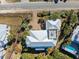 A nice aerial view showcases the house's roof, yard, pool, and general surroundings, including nearby buildings and trees at 3030 Marshall Blvd, Sullivans Island, SC 29482