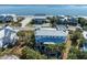 Stunning aerial view of an oceanfront home with a metal roof, lush landscaping, and private beach access at 3030 Marshall Blvd, Sullivans Island, SC 29482