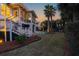 Elegant home with a backyard featuring a pool, lush landscaping, and an outdoor entertaining area with nice palm trees at 3030 Marshall Blvd, Sullivans Island, SC 29482