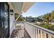 A charming balcony provides a relaxing outdoor space with views of the surrounding neighborhood and lush greenery at 3030 Marshall Blvd, Sullivans Island, SC 29482
